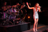 Mariah Carey performs on stage in small silver dress showing her legs and cleavage at Time Magazine 100 Most Influential People Event